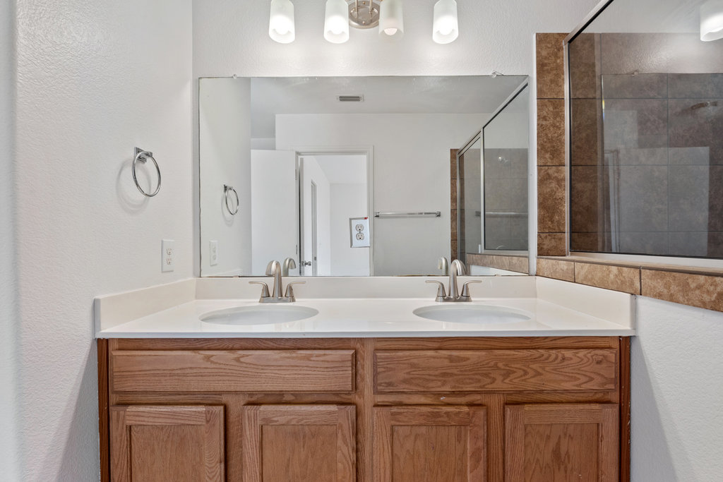 117 Wapiti Road Buda, TX 78610 - Photo 22 of 35 a bathroom with a sink vanity and a mirror