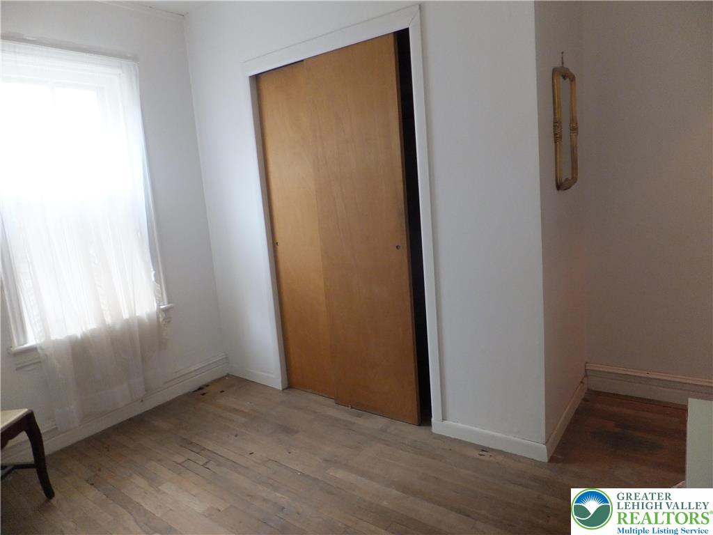 7 North 4th Street Coplay, PA 18037 - Photo 14 of 23 a view of an empty room with wooden floor and a window