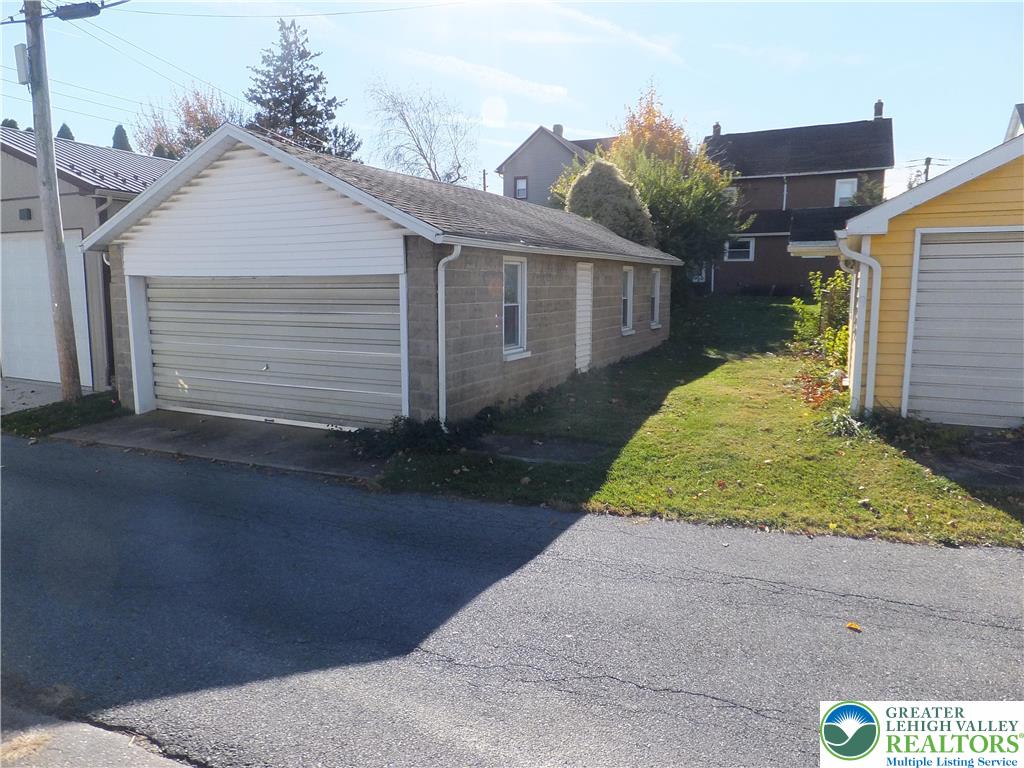 7 North 4th Street Coplay, PA 18037 - Photo 22 of 23 a front view of a house with a yard and garage