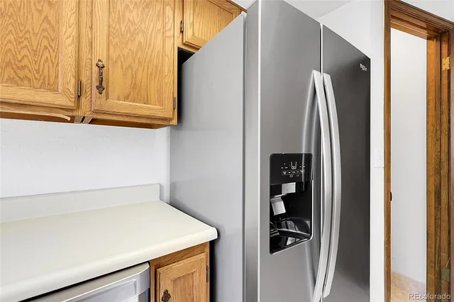 a kitchen with a refrigerator and cabinets