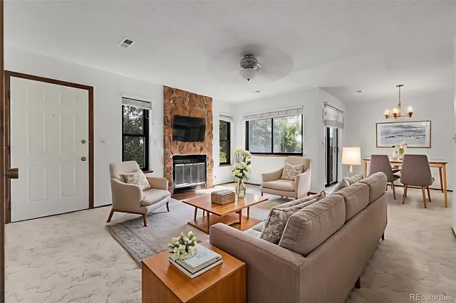 a living room with fireplace furniture and a flat screen tv