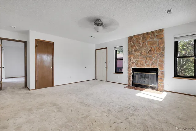 a view of empty room with a fireplace