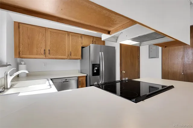 a kitchen with stainless steel appliances granite countertop a sink refrigerator and microwave