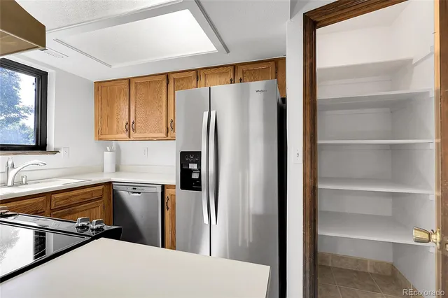 a kitchen with a refrigerator and a sink
