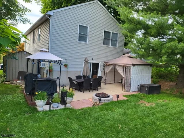 a view of a house with a yard and sitting area