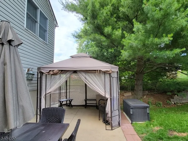 a view of house with backyard outdoor seating and green space