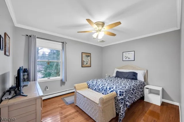 a bedroom with a bed a couch and a window