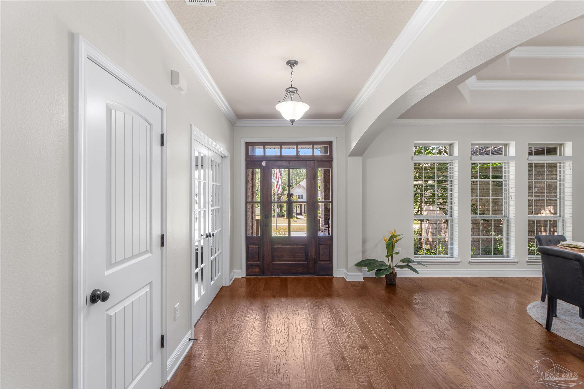 2698 Tulip Hill Road Pace, FL 32571 - Photo 6 of 65 wooden floor in an empty room with a window