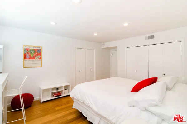 a bedroom with a bed and a cabinets