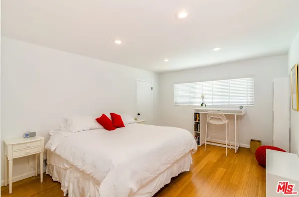 a bedroom with a bed and a closet