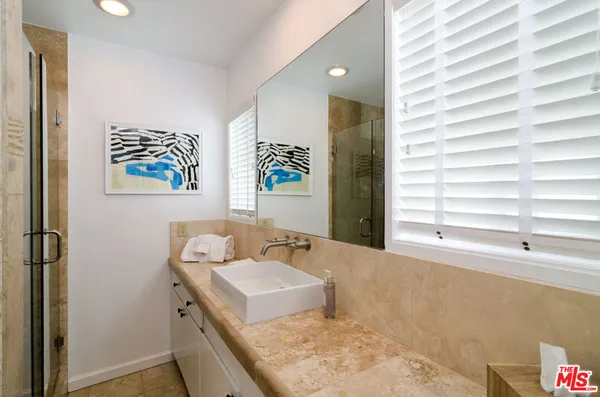 a bathroom with a granite countertop sink and a mirror