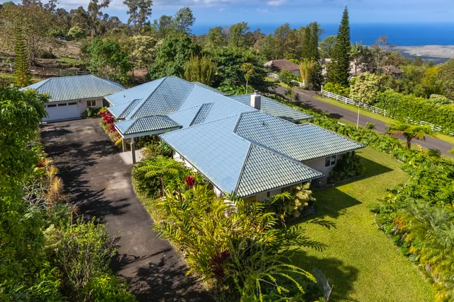 an aerial view of a house with a yard