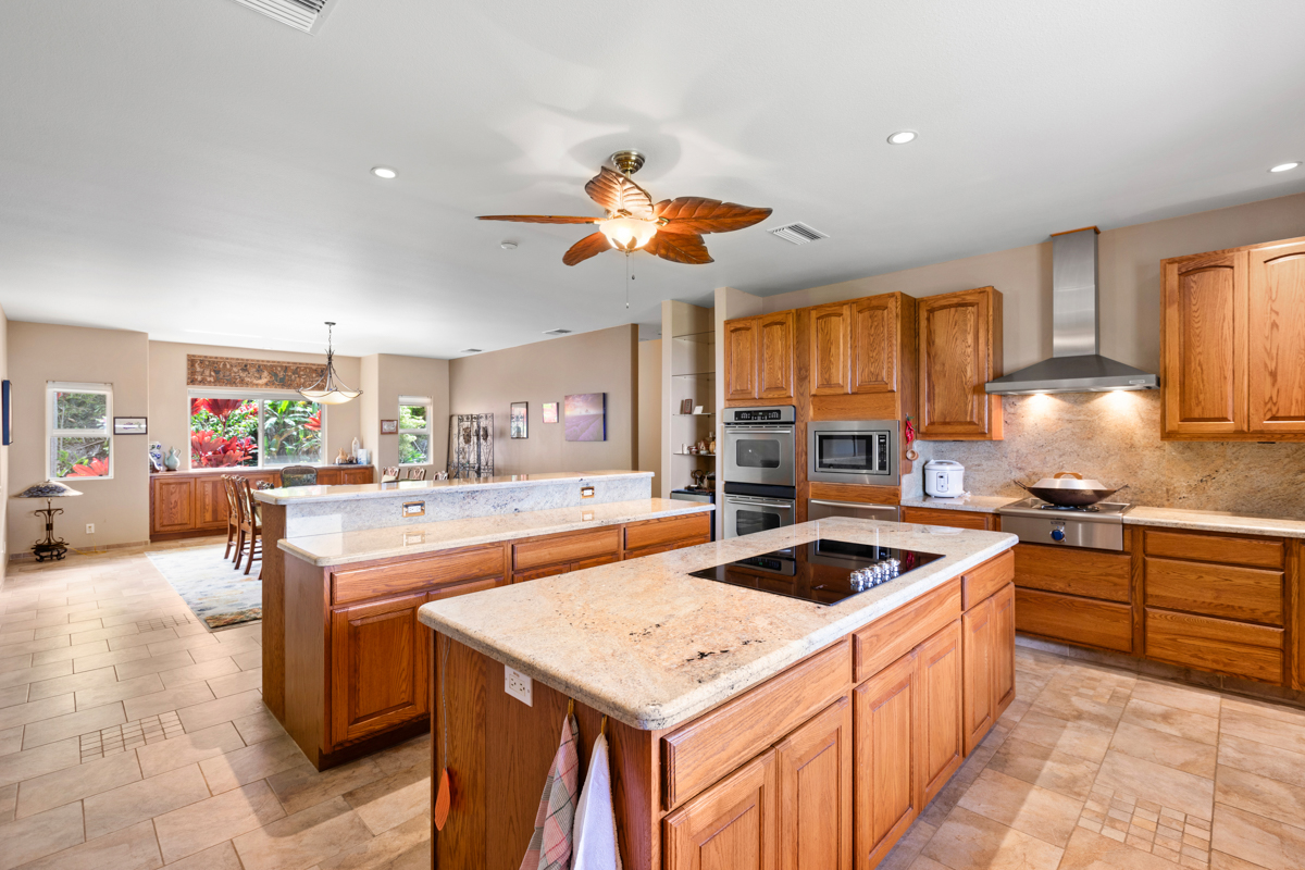 73-4571 Kukuki Street, Unit A Kailua-Kona, HI 96740 - Photo 12 of 30 a kitchen with granite countertop a sink a counter top space and stainless steel appliances