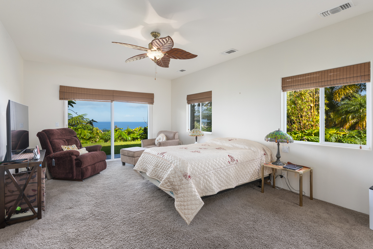 73-4571 Kukuki Street, Unit A Kailua-Kona, HI 96740 - Photo 13 of 30 a bed room with a bed and a couch