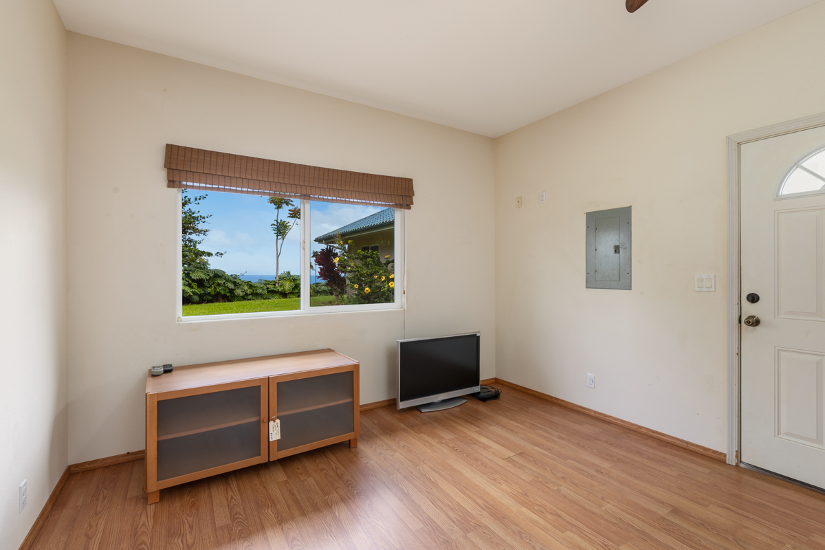 73-4571 Kukuki Street, Unit A Kailua-Kona, HI 96740 - Photo 22 of 30 a view of room with hardwood floor and cabinet