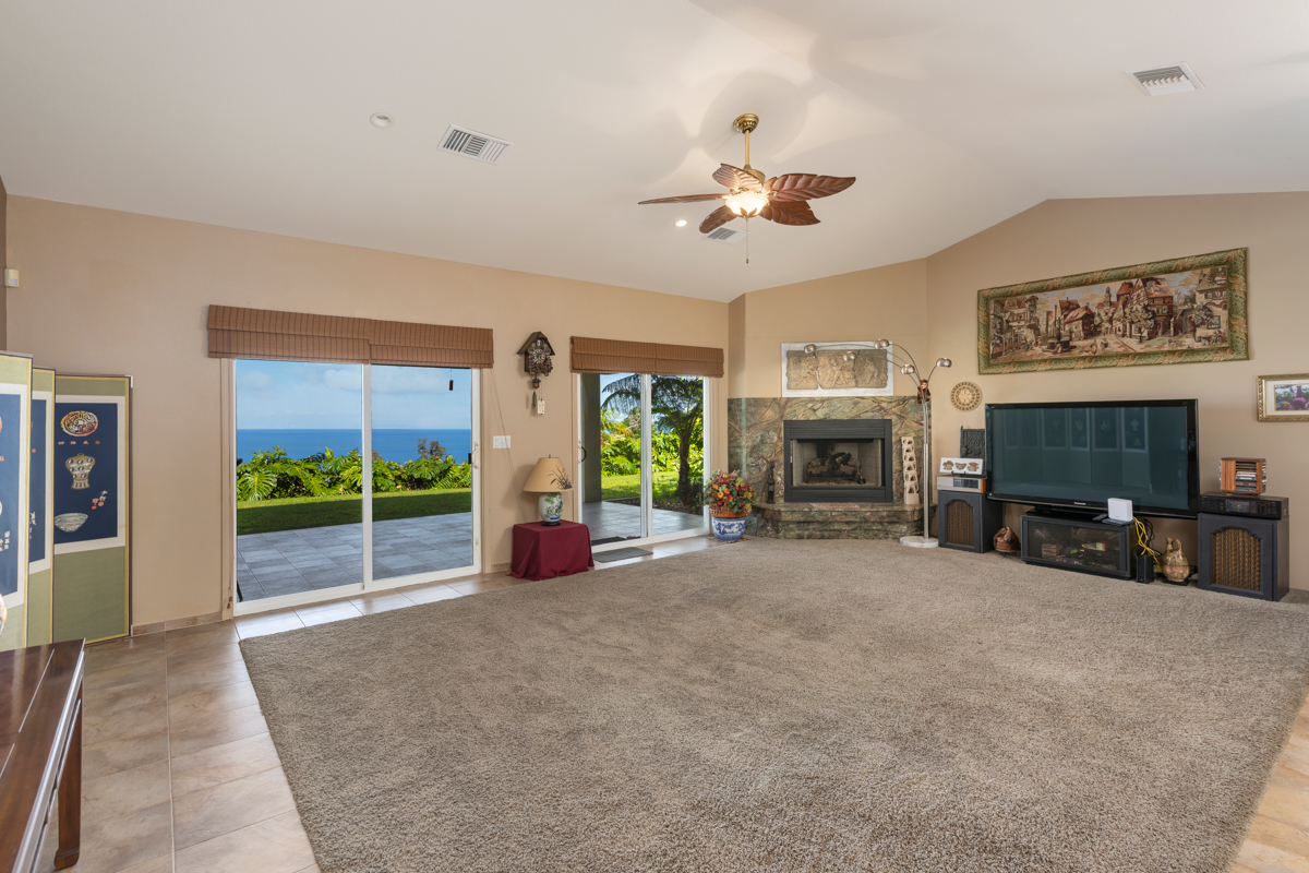 73-4571 Kukuki Street, Unit A Kailua-Kona, HI 96740 - Photo 6 of 30 a view of a livingroom with furniture a fireplace and windows