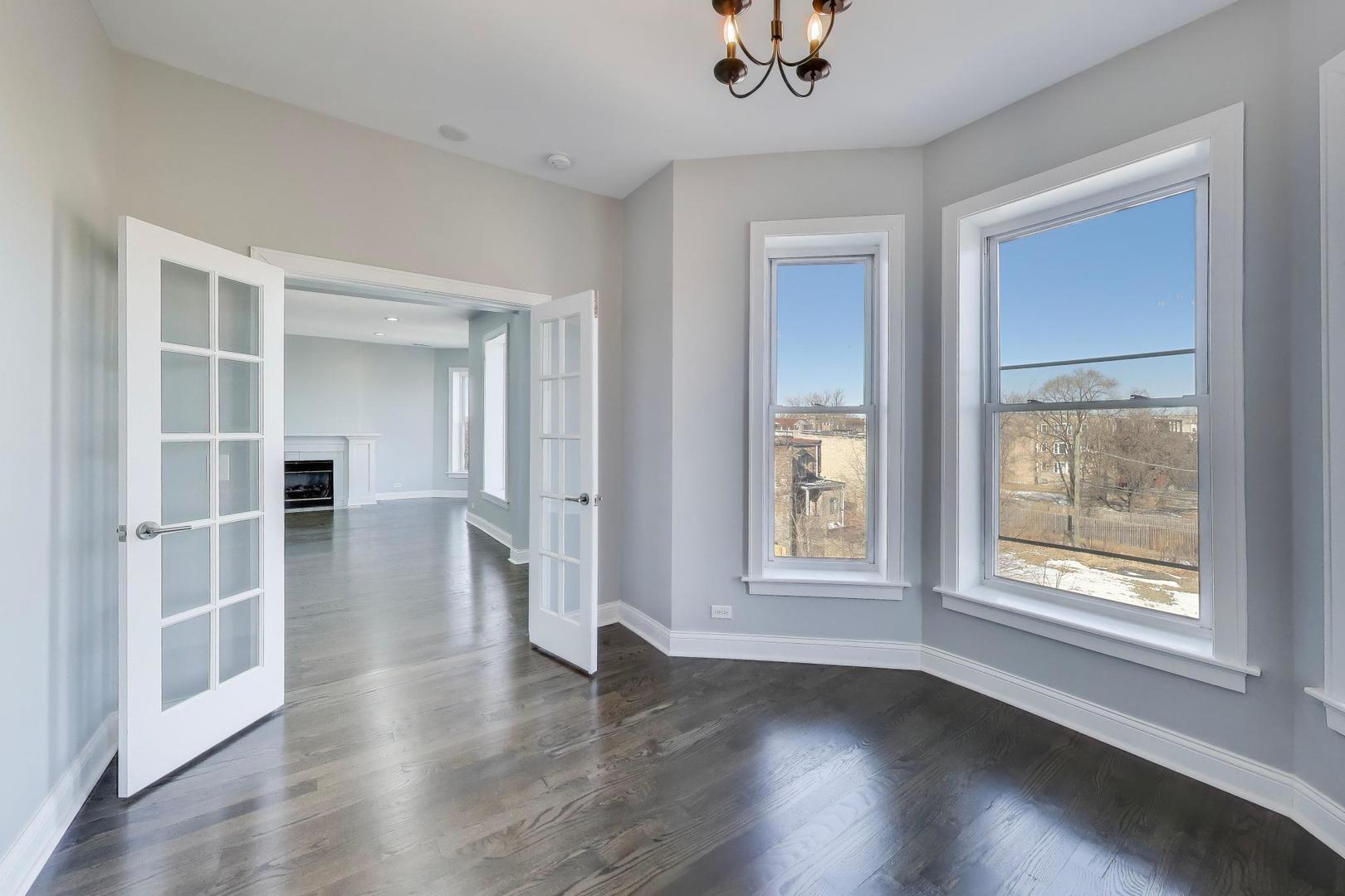 313 East 60th Street, Unit 4 Chicago, IL 60637 - Photo 21 of 42 wooden floor in an empty room with a window