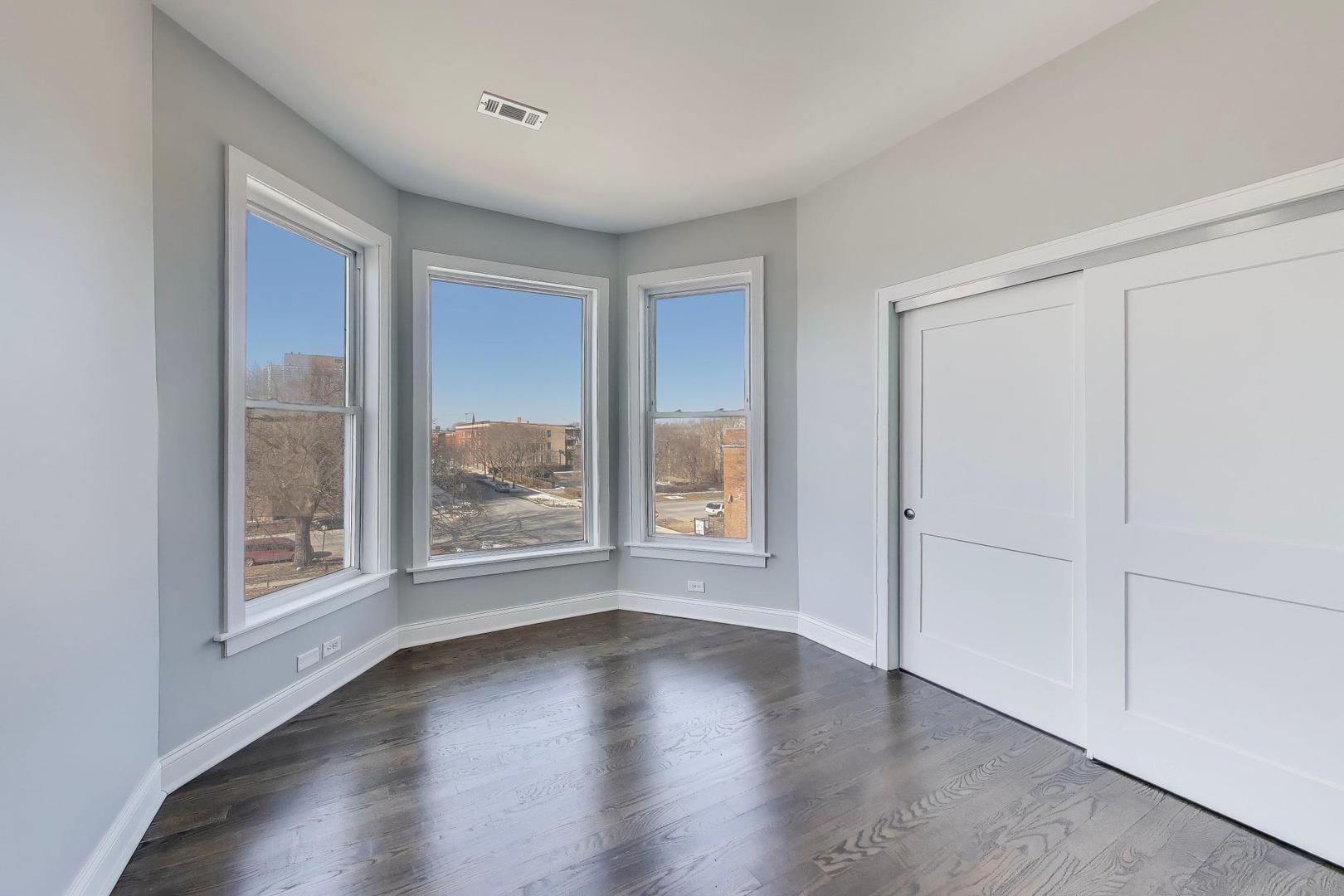 313 East 60th Street, Unit 4 Chicago, IL 60637 - Photo 39 of 42 a view of wooden floor and windows in a room