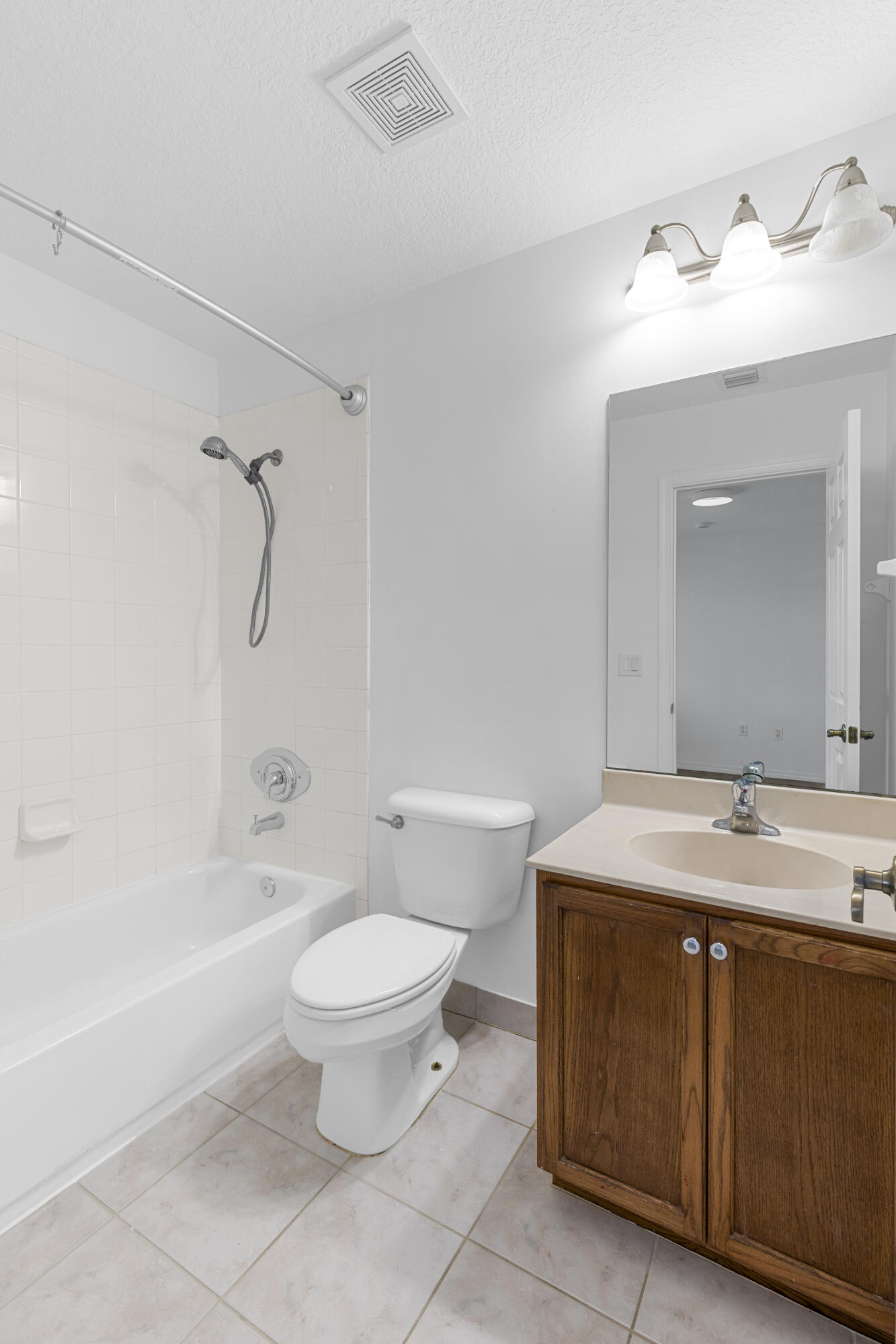 9107 Chambers Street, Unit 9107 Tamarac, FL 33321 - Photo 19 of 30 a bathroom with a sink a toilet and a mirror