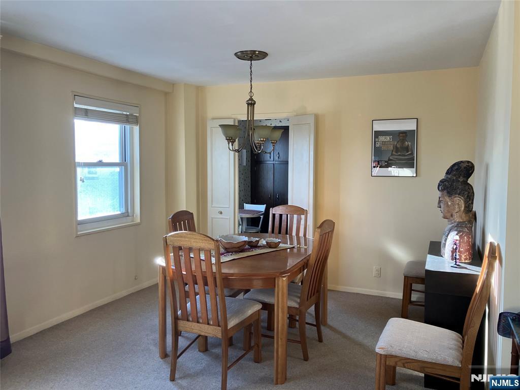280 Prospect Avenue, Unit 11H Hackensack, NJ 07601 - Photo 9 of 20 a dining room with furniture and window