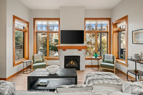 a living room with furniture fireplace and flat screen tv
