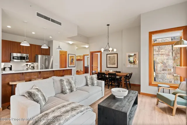 a bedroom with a large bed and a flat tv screen next to a large window