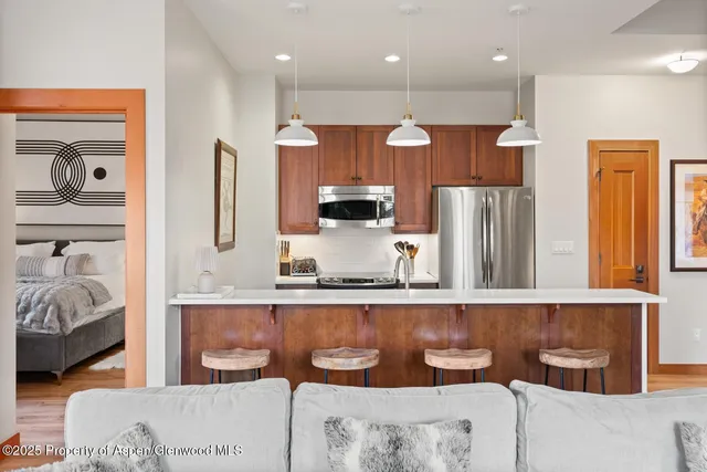 a living room with fireplace furniture and a floor to ceiling window