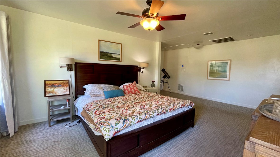 704 Colorado Street Bremond, TX 76629 - Photo 11 of 42 a bed sitting in a bedroom next to a window and a chandelier