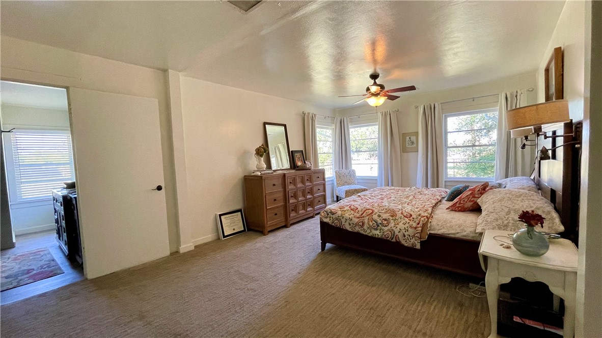 704 Colorado Street Bremond, TX 76629 - Photo 12 of 42 a bedroom with a bed closet and flat tv screen