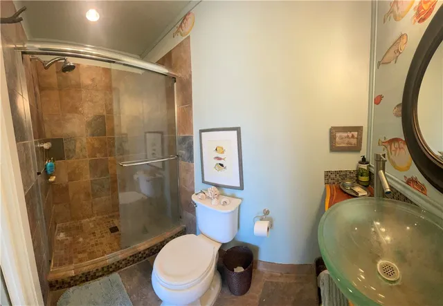 a bathroom with a toilet and a shower