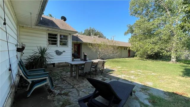 a view of a chair and table on the patio
