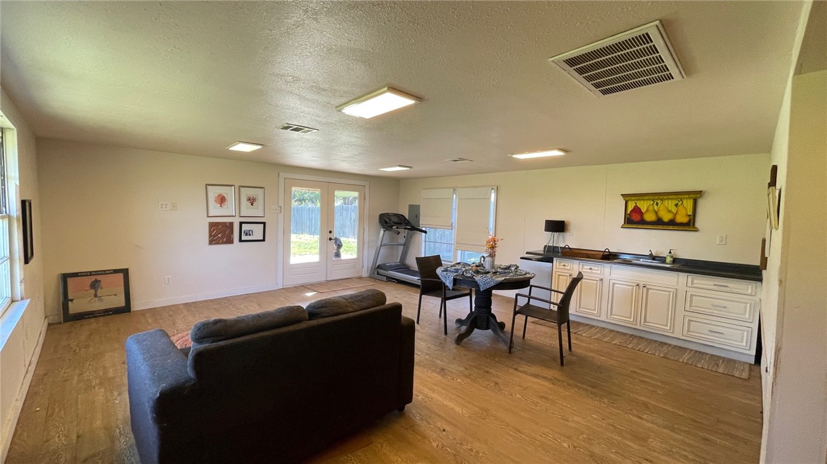 704 Colorado Street Bremond, TX 76629 - Photo 37 of 42 a living room with furniture and a wooden floor