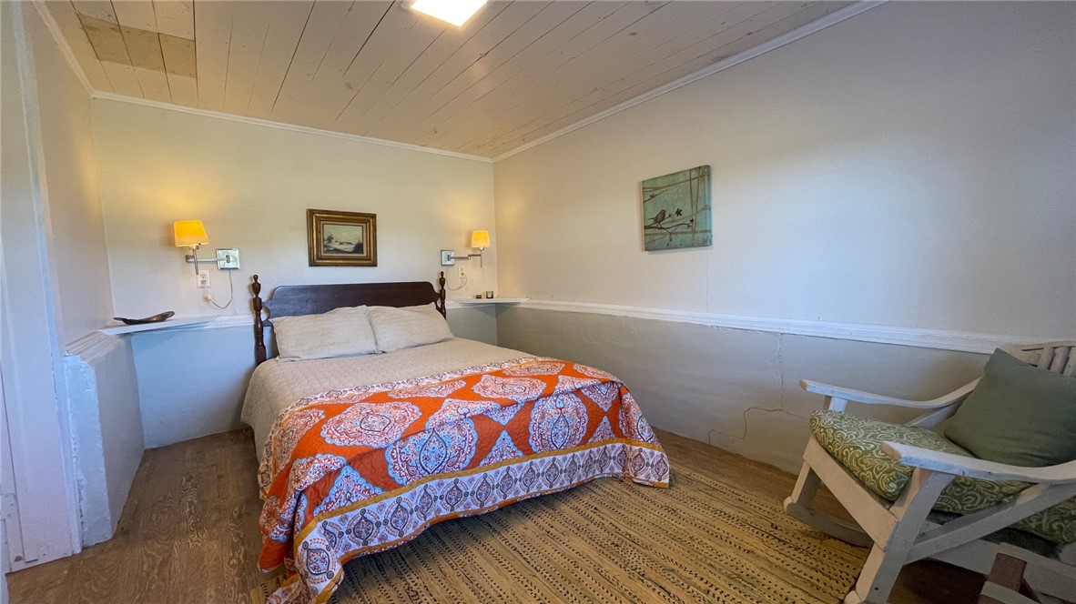 704 Colorado Street Bremond, TX 76629 - Photo 39 of 42 a bedroom with a bed and wooden floor