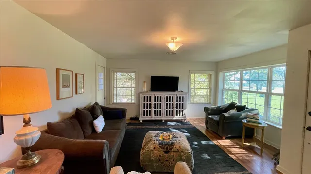 a living room with furniture fireplace and a flat screen tv