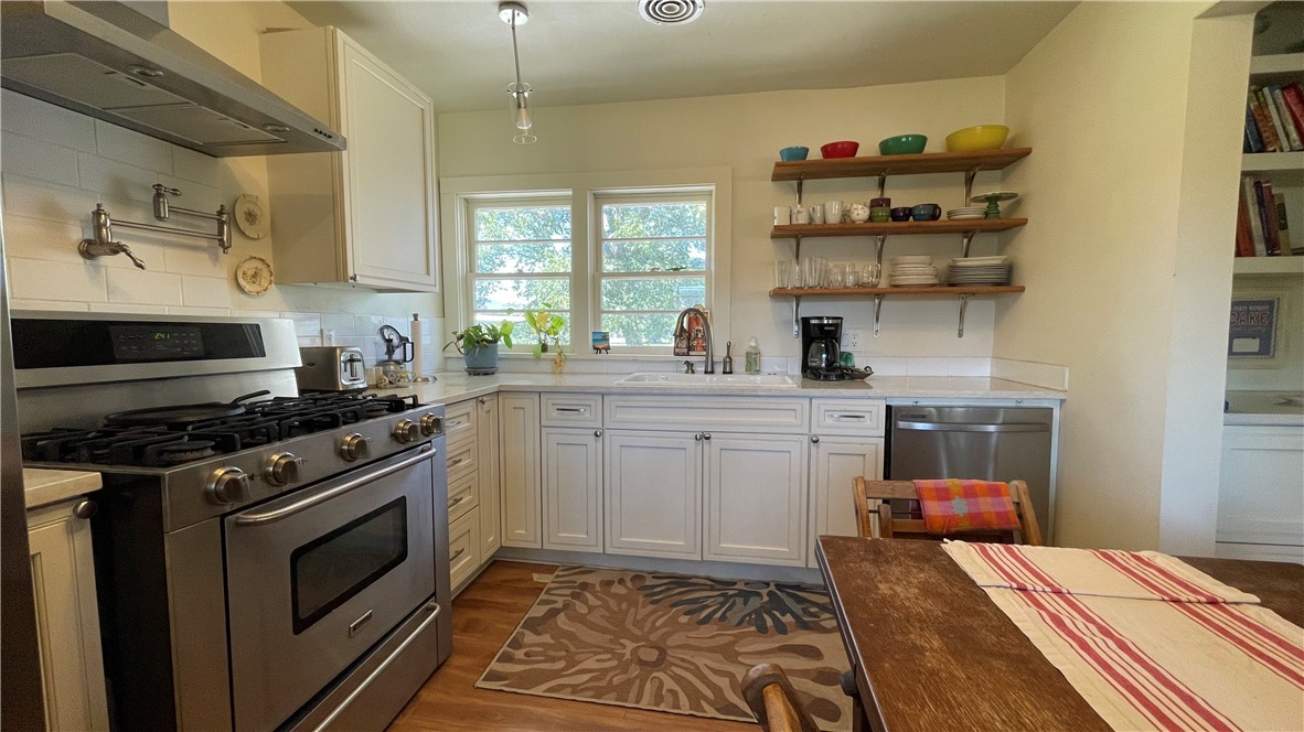 704 Colorado Street Bremond, TX 76629 - Photo 8 of 42 a kitchen with a stove and cabinets