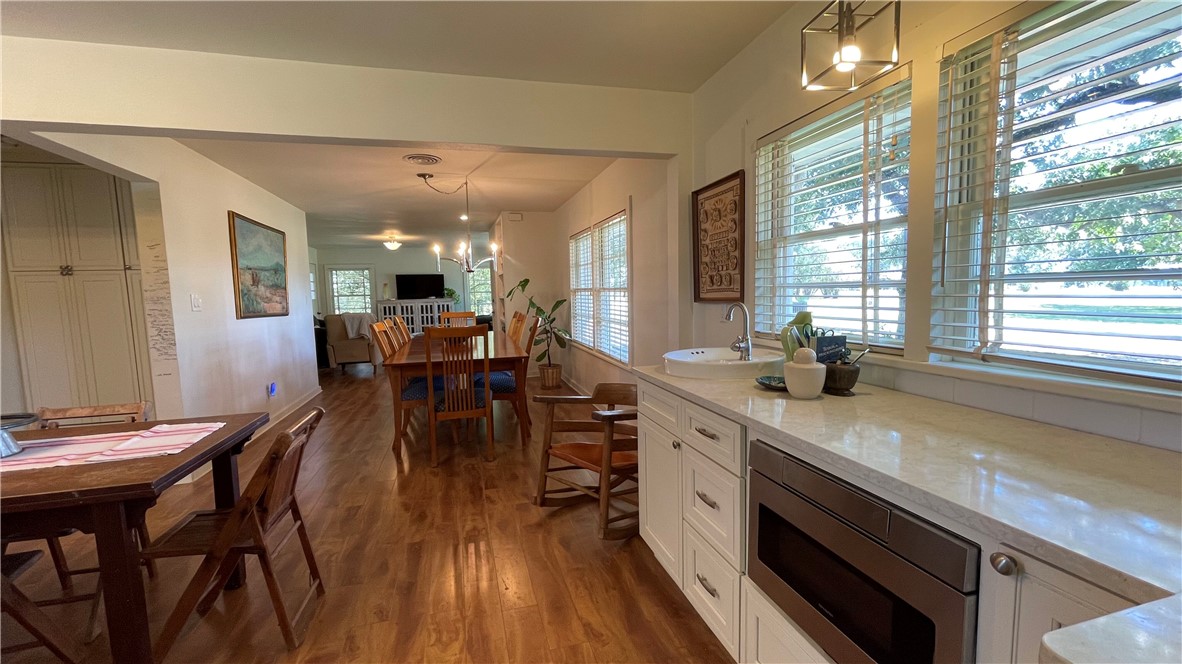 704 Colorado Street Bremond, TX 76629 - Photo 9 of 42 a view of a dining room with furniture and wooden floor