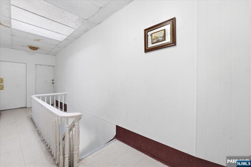 509 Monastery Place Union City, NJ 07087 - Photo 13 of 49 a hallway with stairs and a wooden floor