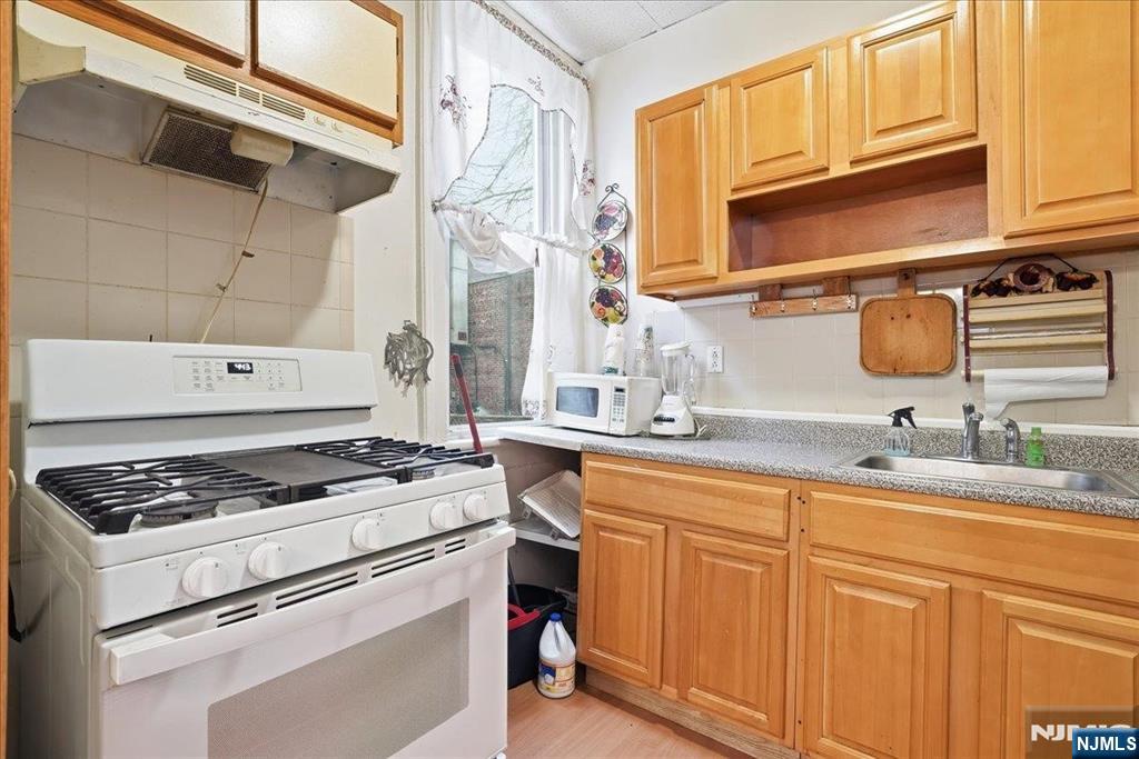 509 Monastery Place Union City, NJ 07087 - Photo 14 of 49 a kitchen with stainless steel appliances granite countertop a sink stove and cabinets