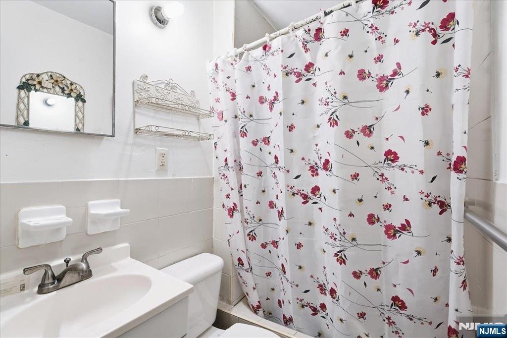 509 Monastery Place Union City, NJ 07087 - Photo 20 of 49 a bathroom with a sink and a mirror
