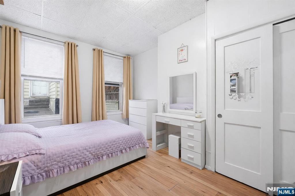 509 Monastery Place Union City, NJ 07087 - Photo 25 of 49 a bedroom with a bed and a table with wooden floor