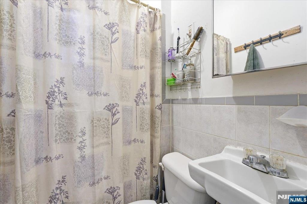 509 Monastery Place Union City, NJ 07087 - Photo 4 of 49 a bathroom with a shower and a sink