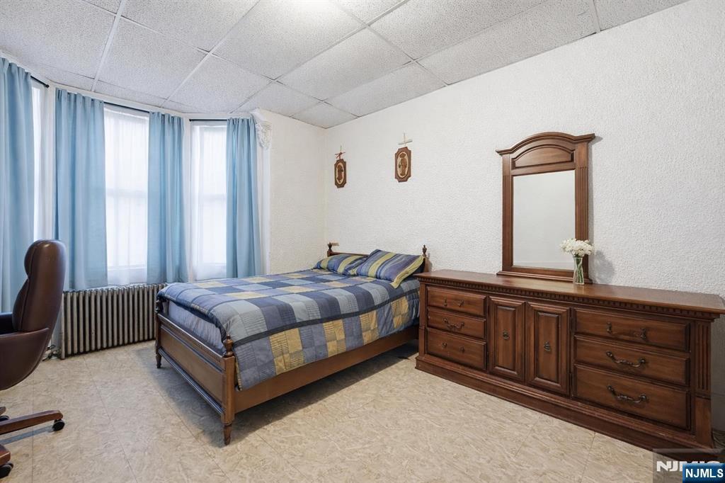 509 Monastery Place Union City, NJ 07087 - Photo 5 of 49 a bedroom with a bed and a dresser