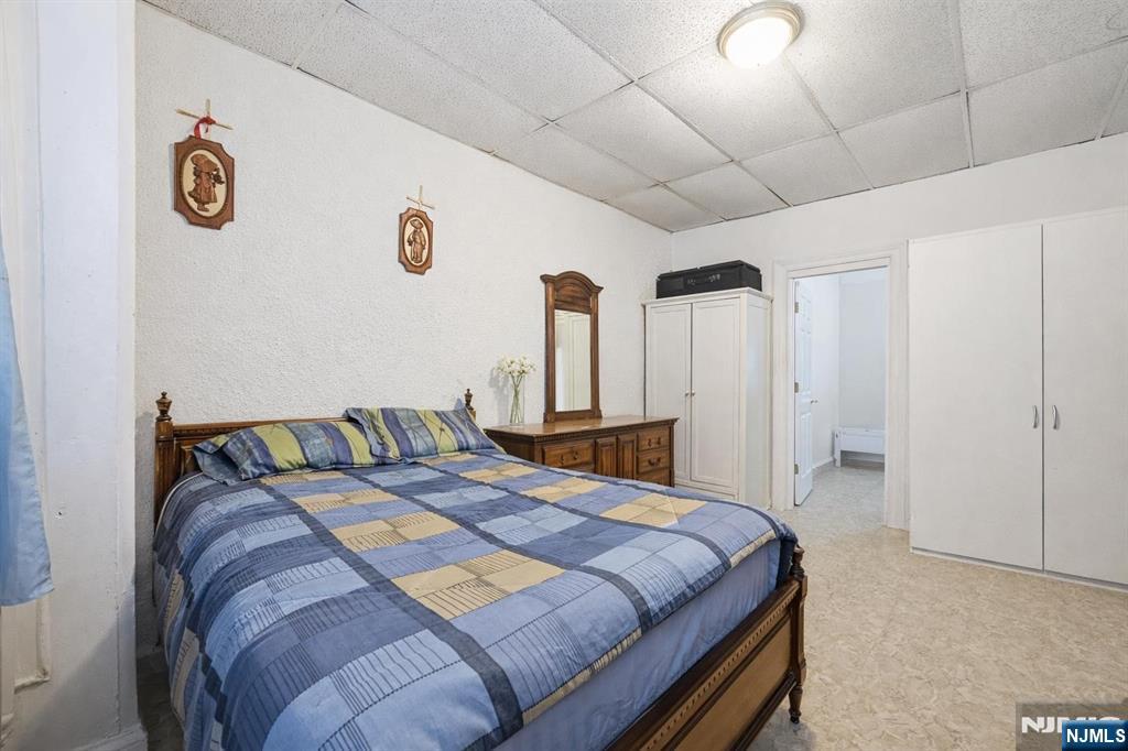 509 Monastery Place Union City, NJ 07087 - Photo 6 of 49 a bedroom with a bed and a wall painting