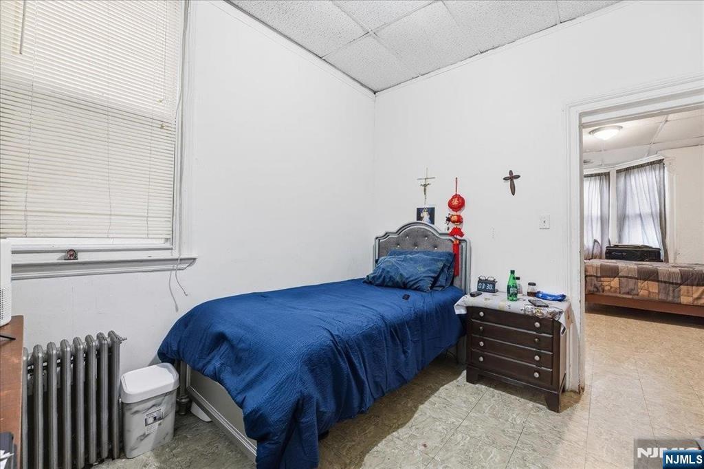 509 Monastery Place Union City, NJ 07087 - Photo 7 of 49 a bedroom with a bed and a couch