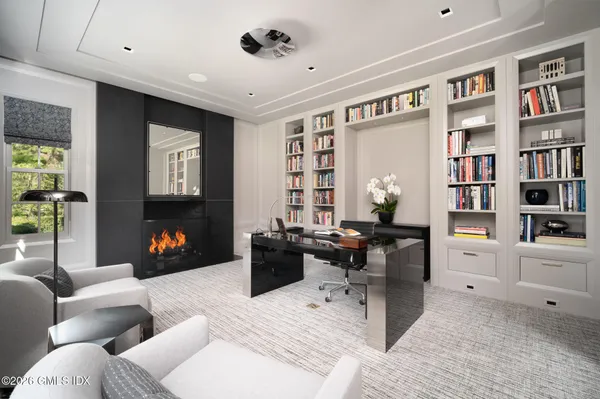 a spacious bedroom with furniture and a flat screen tv