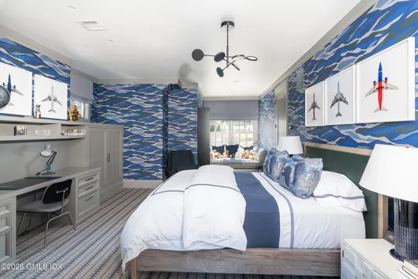 a bedroom with furniture and a flat screen tv