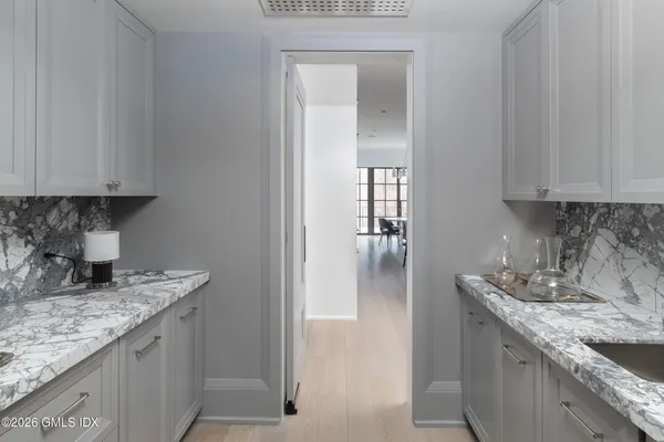 a kitchen with stainless steel appliances a stove a table and chairs in it