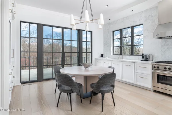 a kitchen with stainless steel appliances a sink a stove and a wooden floors