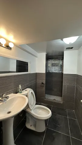 a kitchen with a sink a refrigerator and cabinets
