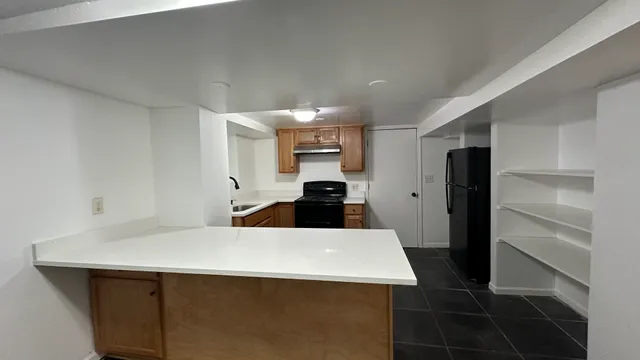 a kitchen with a sink appliances and cabinets